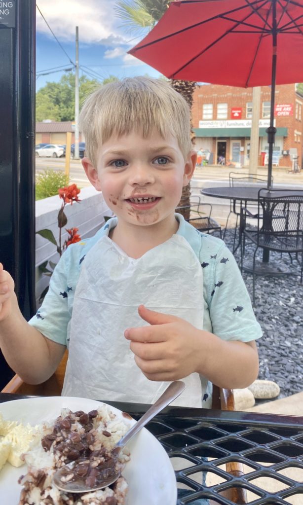 child eating rice and beans