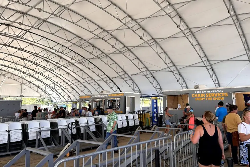 A covered area at the Blue Angels practice show with rows of chairs available for spectators, including a concession stand in the background. National Naval Aviation Museum, Pensacola, Florida