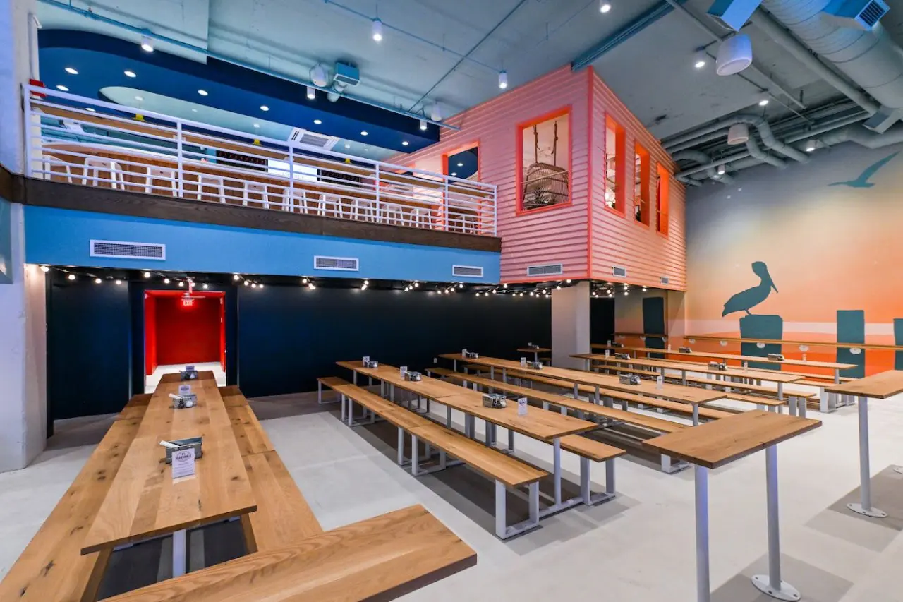 Boardwalk Bar & Arcade restaurant with long wooden communal tables and benches.