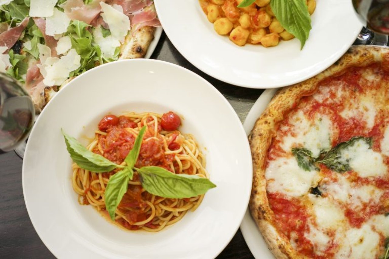 A top-down view of a table filled with Italian dishes.