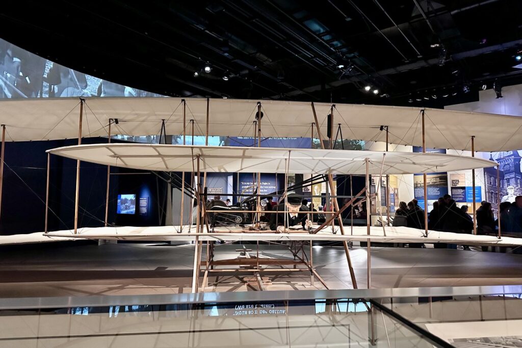 A full-scale replica of the Wright brothers' first airplane displayed in the Air and Space Museum. Washington DC Itinerary