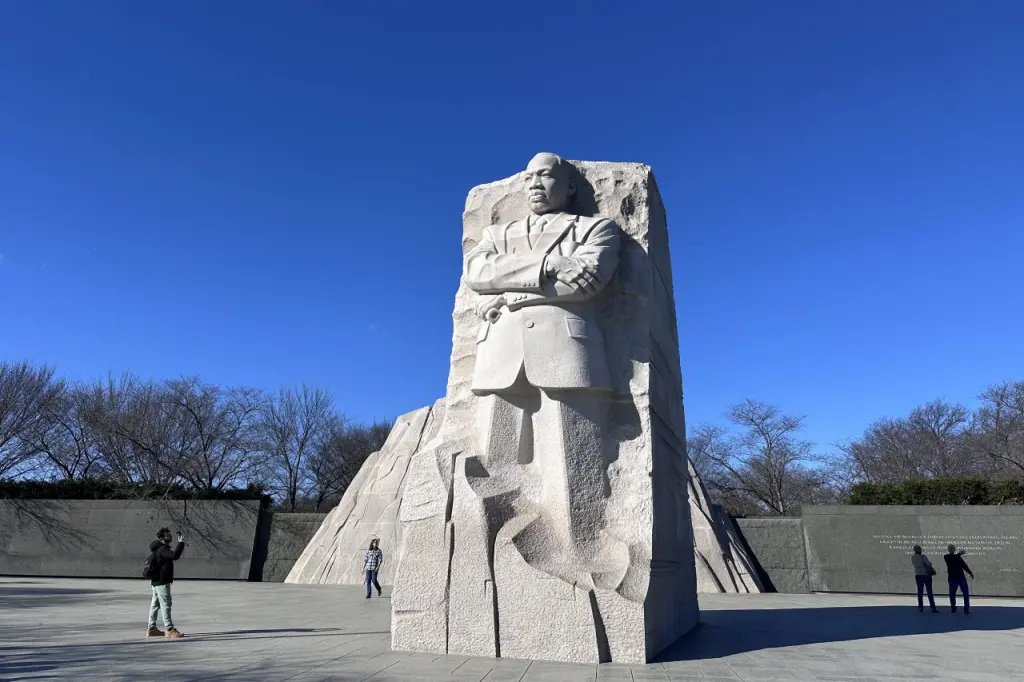 The Martin Luther King Jr. Memorial with a large statue of Dr. King against a clear blue sky.