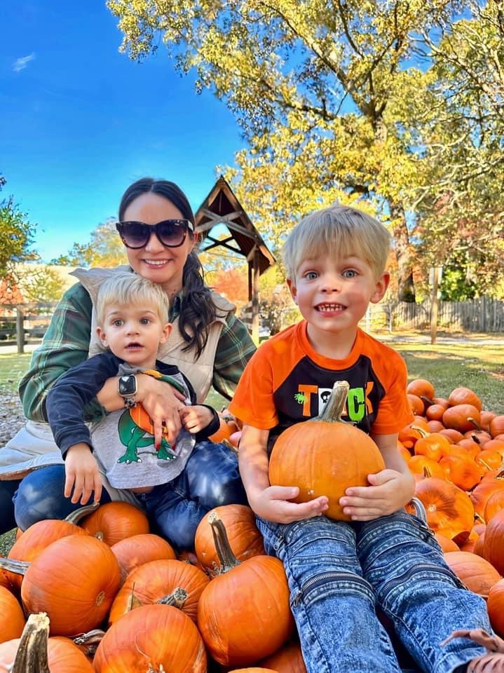 A mom and two young boys enjoying a pumpkin patch near Atlanta, Georgia