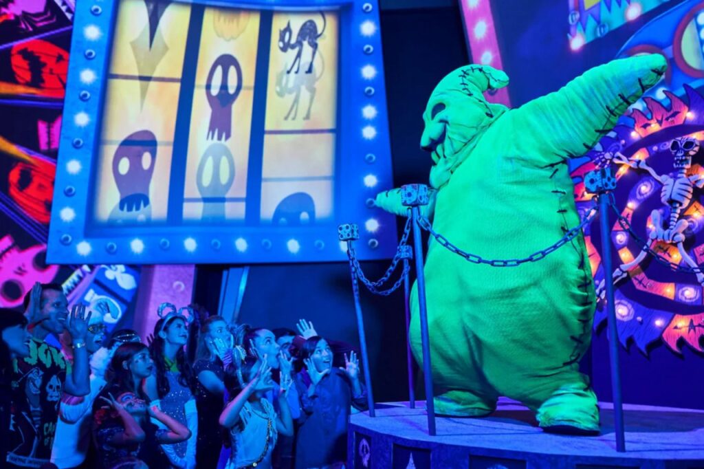 Oogie Boogie character from The Nightmare Before Christmas performing on stage in front of a crowd during Disneyland’s Halloween celebration.