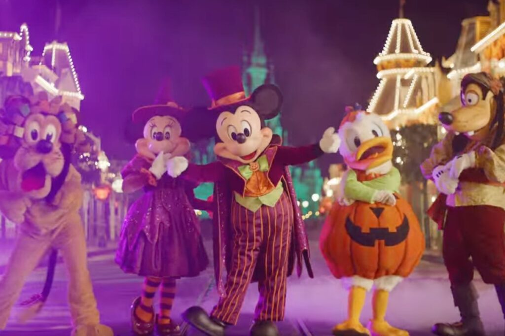 Mickey, Minnie, Donald, Goofy, and Pluto dressed in Halloween costumes posing on Main Street during Mickey’s Not-So-Scary Halloween Party at Walt Disney World.