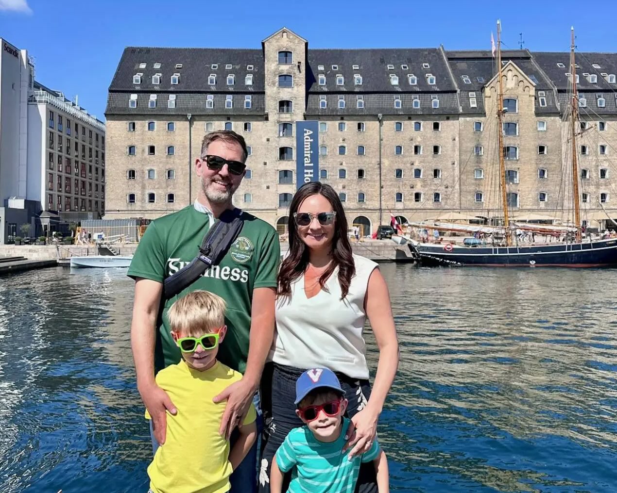 Family of 4 stands in front of a canal in Copenhagen, Denmark