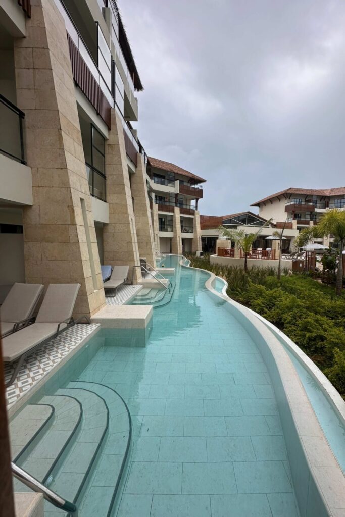 Swim-out pool corridor running alongside ground-floor rooms at Dreams Playa Esmeralda