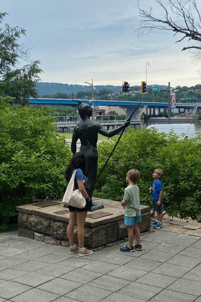 Mom and two boys looking up at the Cherokee statue along the Chattanooga riverfront