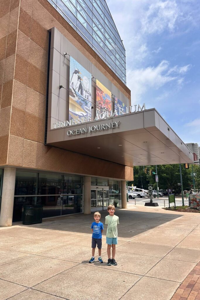 Two boys standing outside the Tennessee Aquarium Ocean Journey entrance in downtown Chattanooga