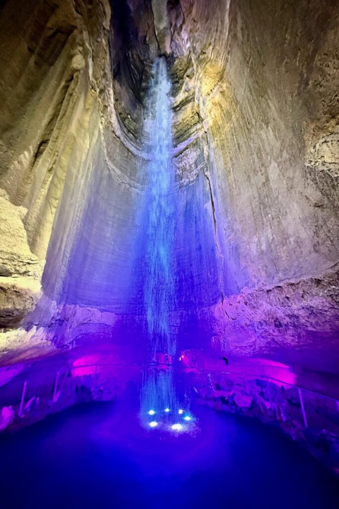 Ruby Falls underground waterfall lit in blue and purple inside Lookout Mountain