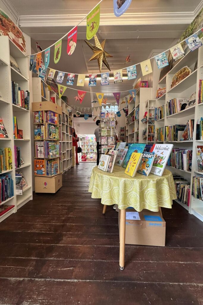 Interior of an independent children's bookshop in Richmond London with picture books and colorful bunting
