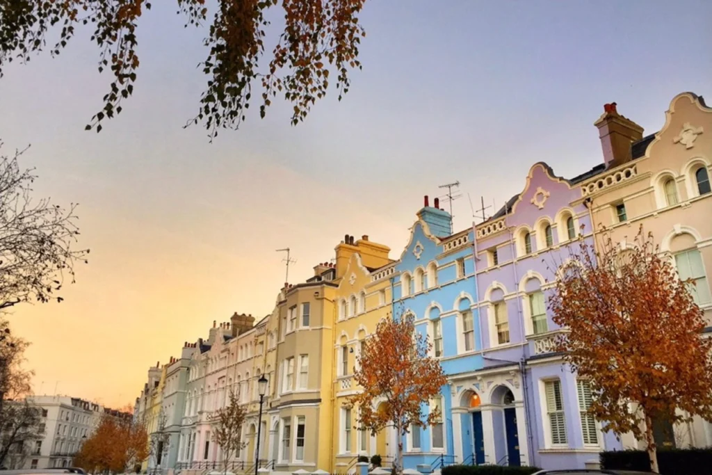 Row of pastel colored houses in Notting Hill, London, at sunset in autumn.