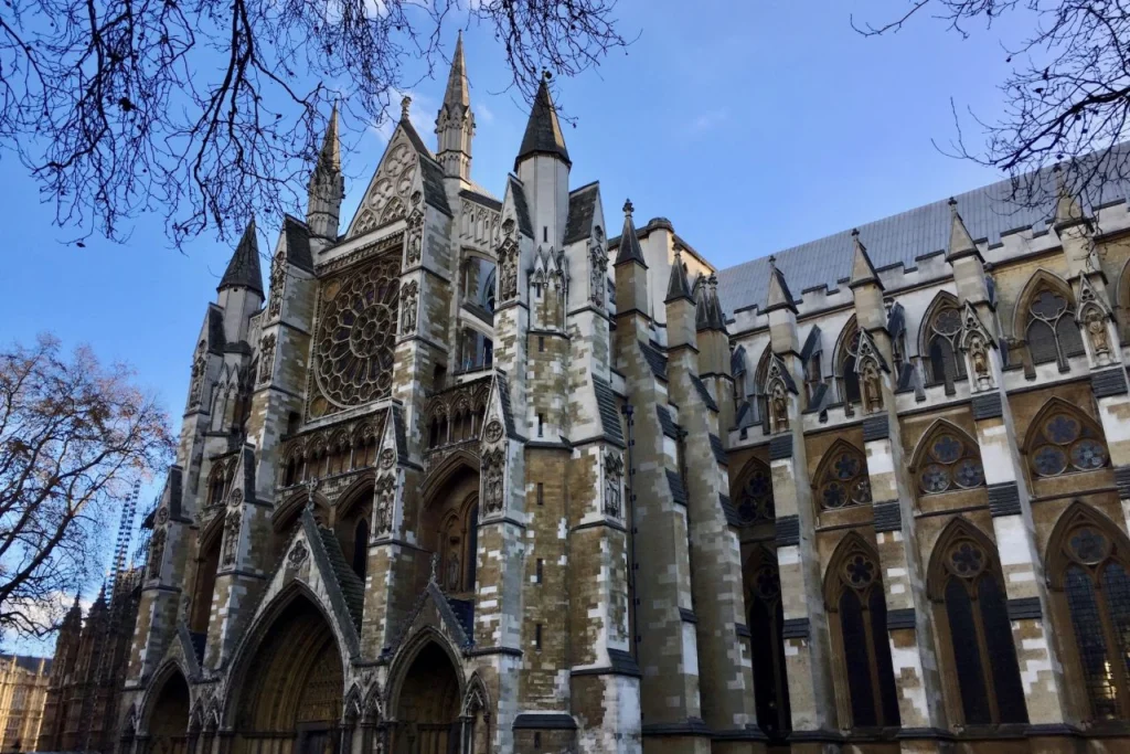 Exterior of Westminster Abbey in London with its rose window and Gothic stonework.
