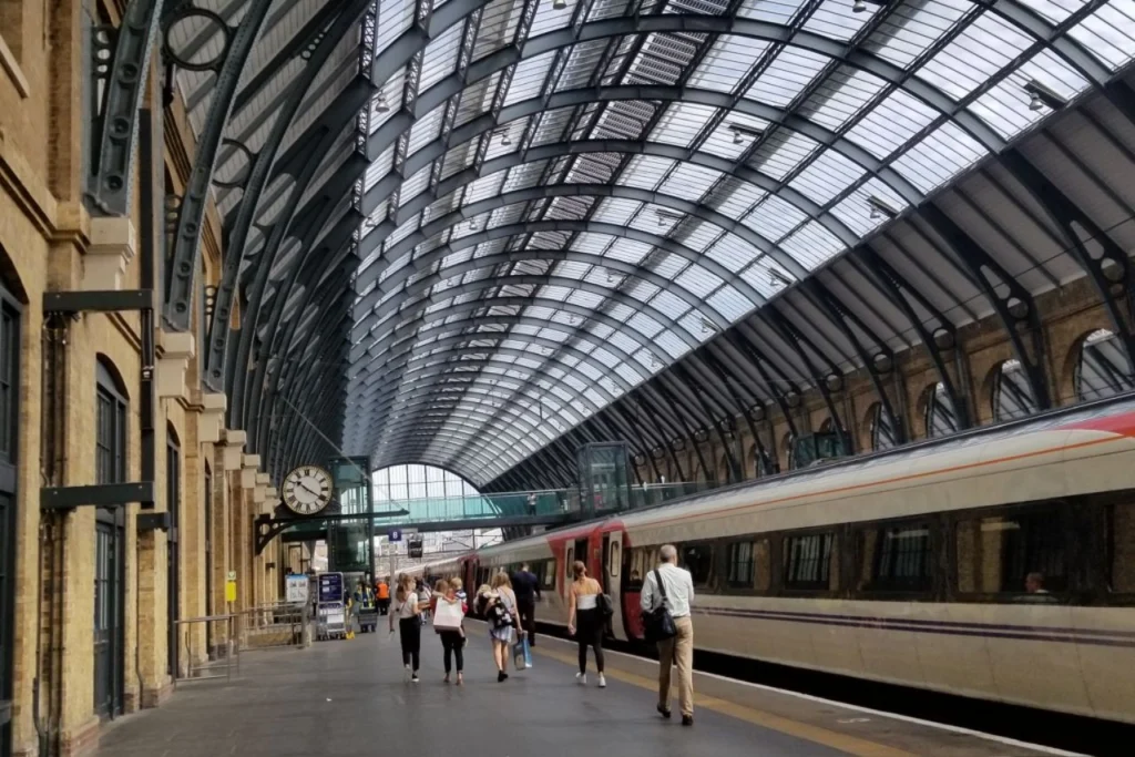 Curved glass and steel roof over the platforms at King's Cross station in London.