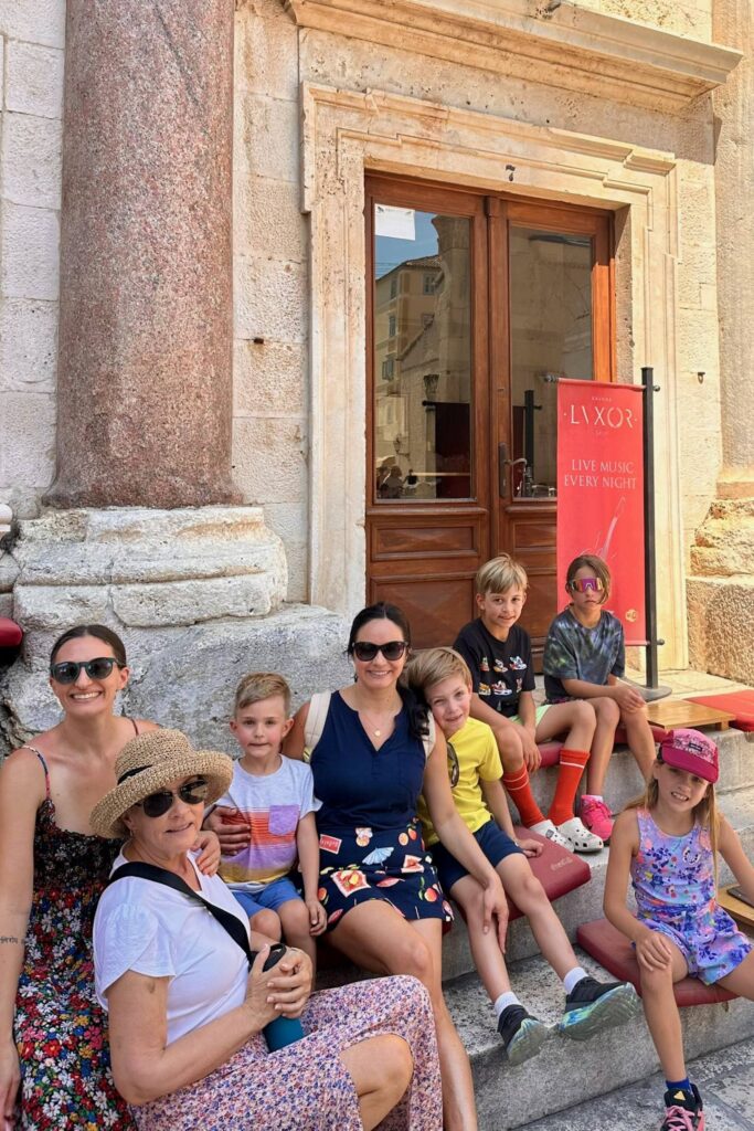 Family resting on the steps of the Peristyle inside Diocletian’s Palace in Split
